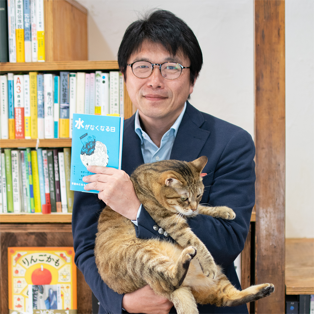 猫を抱える橋本淳司さん